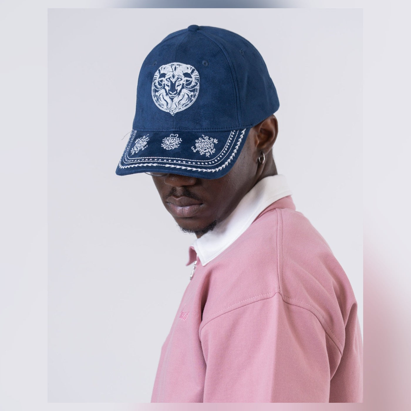 Man wearing the Virgous midnight Heritage Cap with embroidered detailing