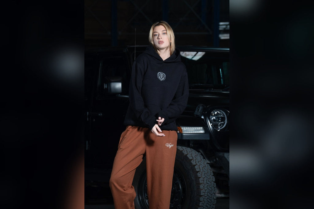 Model wearing a Virgous boxy heritage hoodie, fit guide
